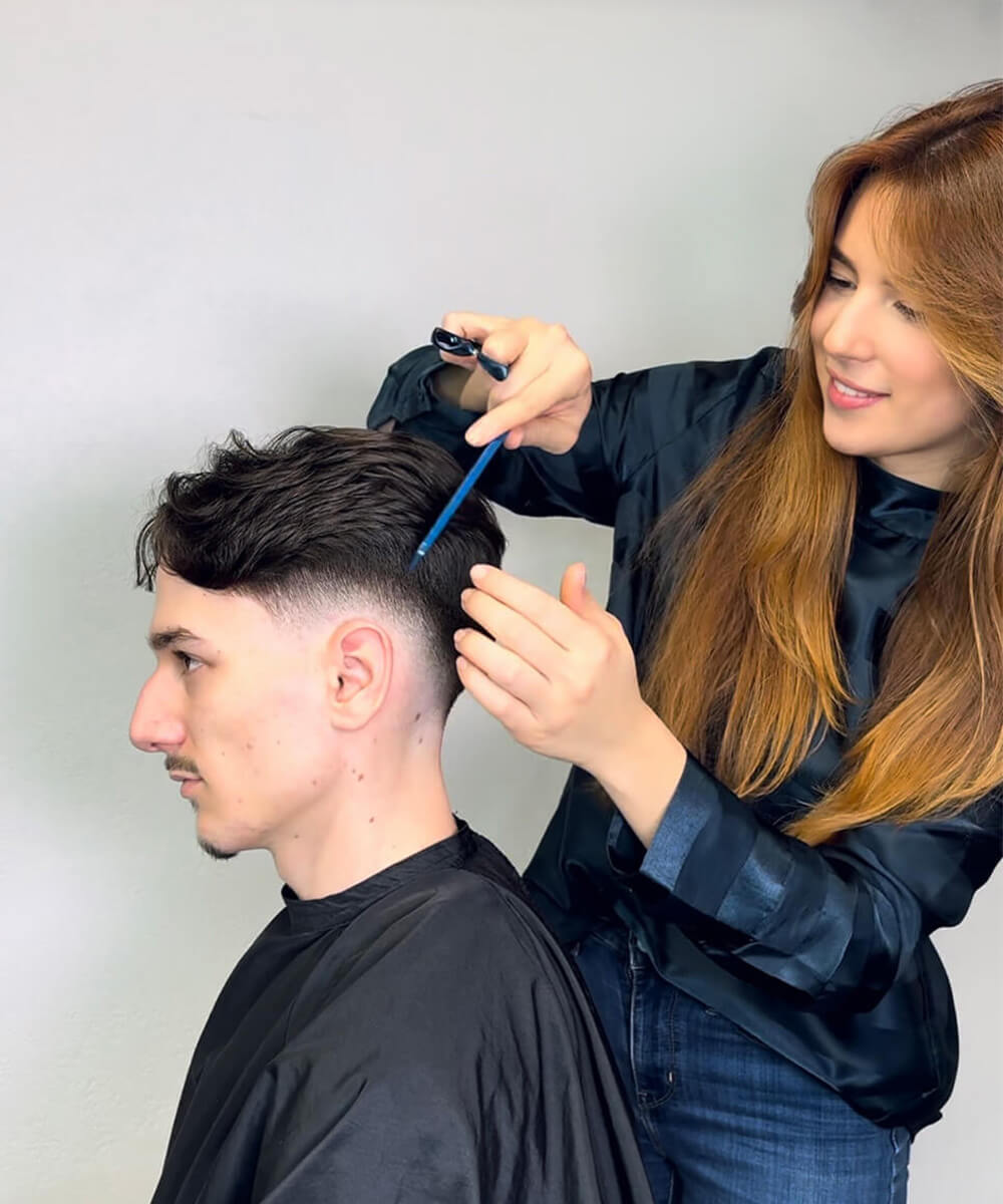 clara quesnes réalisant une coupe homme avec les ciseaux osaka de la collection fade series